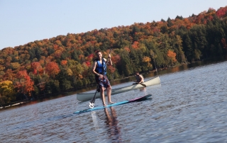 young man on a paddleboard on a lake