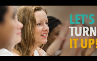 young woman smiling. Text overlay reads "Let's Turn It Up!"